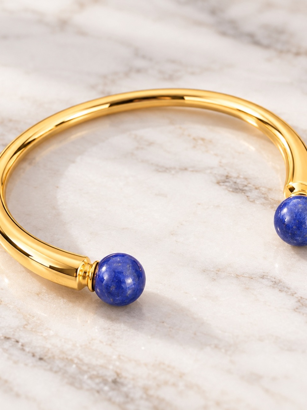 nOir NYC Gold Tone Cuff Bracelet Blue Stone Ends Statement Jewelry